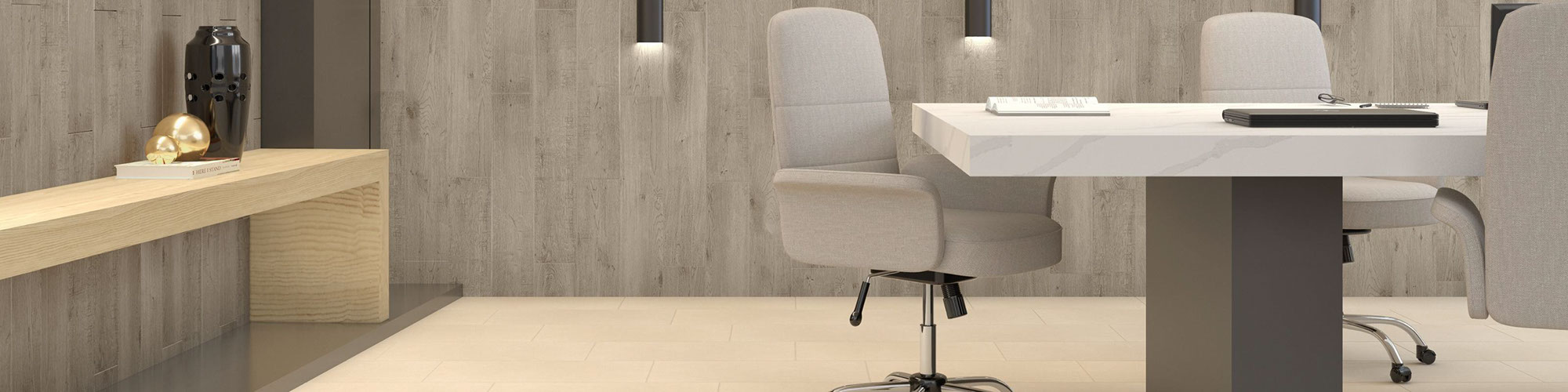 Conference room with beige floor tile, wall tile that looks like weathered wood, wall-mounted lighting, side table, white marble-top table and gray rolling chairs.