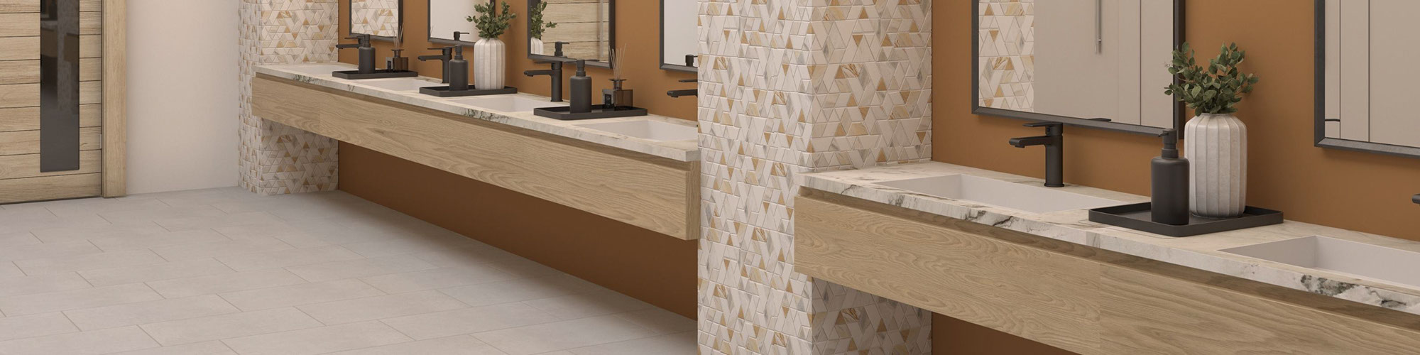 Convention center bathroom with beige floor tile, pillars covered with white marble & brass mosaic tile, floating vanity with under-mount sinks, and mirrors on butterscotch backsplash.