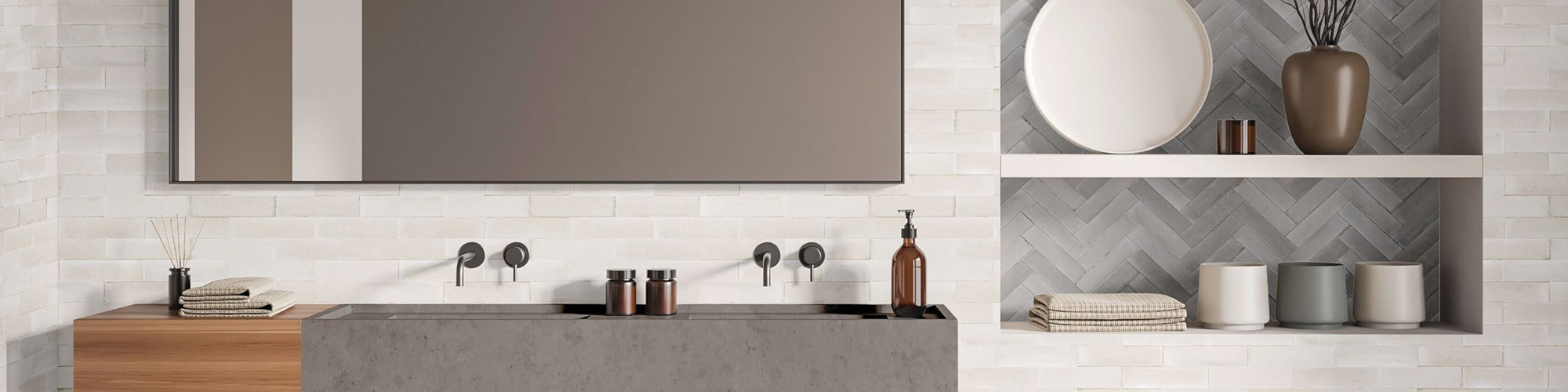 Modern bathroom with off-white subway tile backsplash, gray quartz dual vanity with butcher block accent, built-in shelves with gray herringbone wall tile.