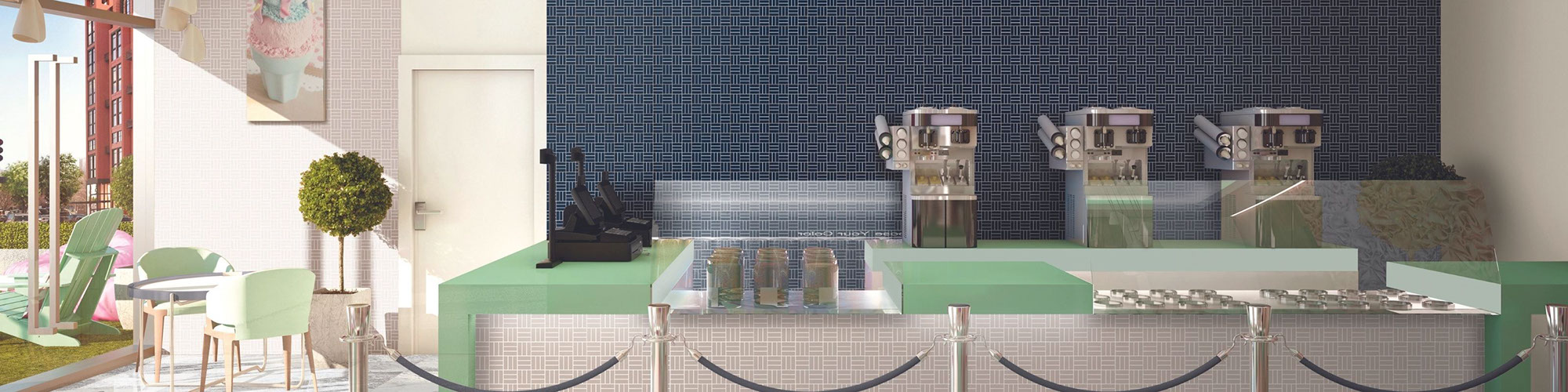 Ice cream parlor with beige mosaic wall tile, navy mosaic feature wall, mint countertop, and white & gray tables with mint chairs.