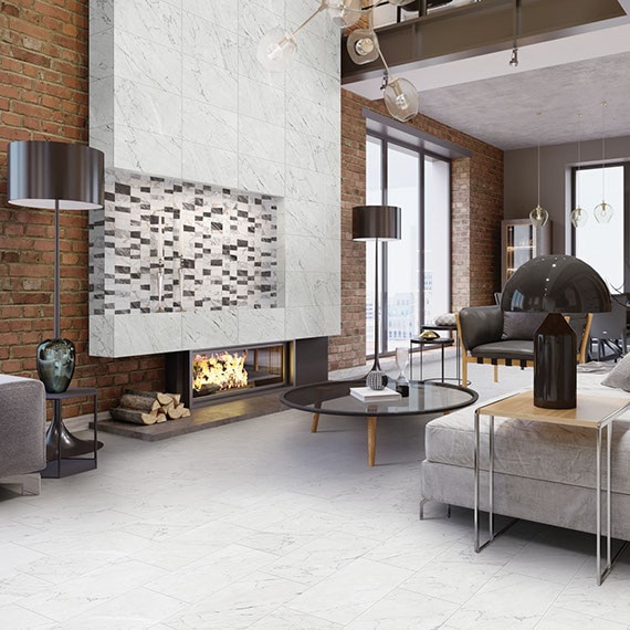Contemporary living room with white marble look tile flooring, matching tile on fireplace mantel with mosaic tile inset, brick wall with floor-to-ceiling windows.