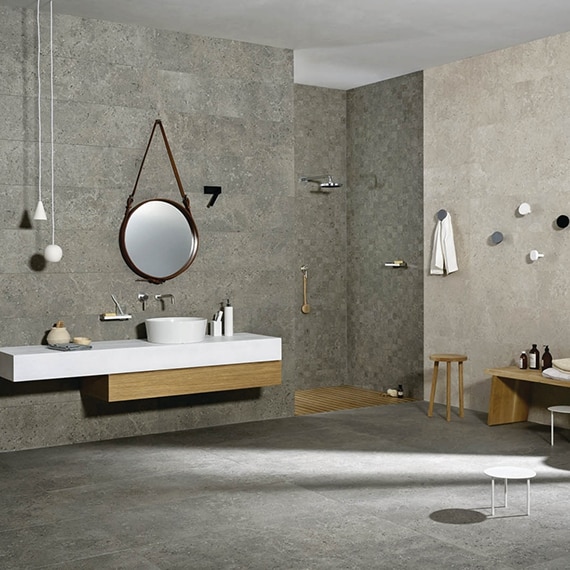 Industrial style bathroom with gray, floor-to-ceiling, concrete look, porcelain tile, concrete look tile floor, and floating vanity.