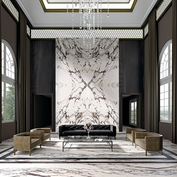 Hotel lobby with white & dark gray marble look porcelain slab flooring and feature wall, large picture windows, and tray ceiling with crystal chandelier.