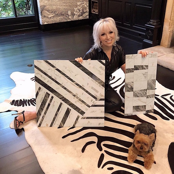 Lifestyle expert and Housewives of New Jersey alum Margaret Josephs holding black & white mosaic tile pieces that look like marble.